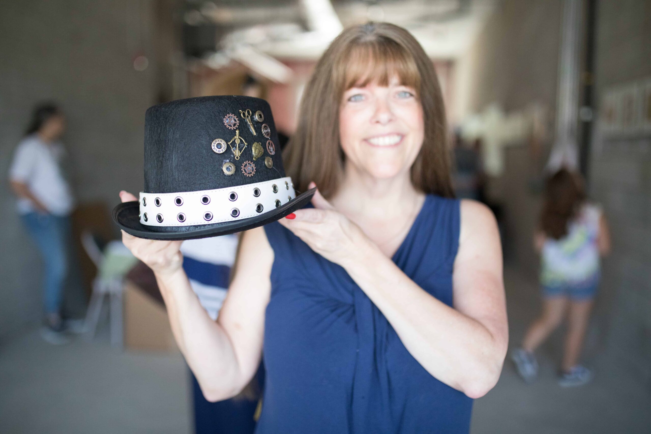 A woman shows off a Steampunk style tophat.