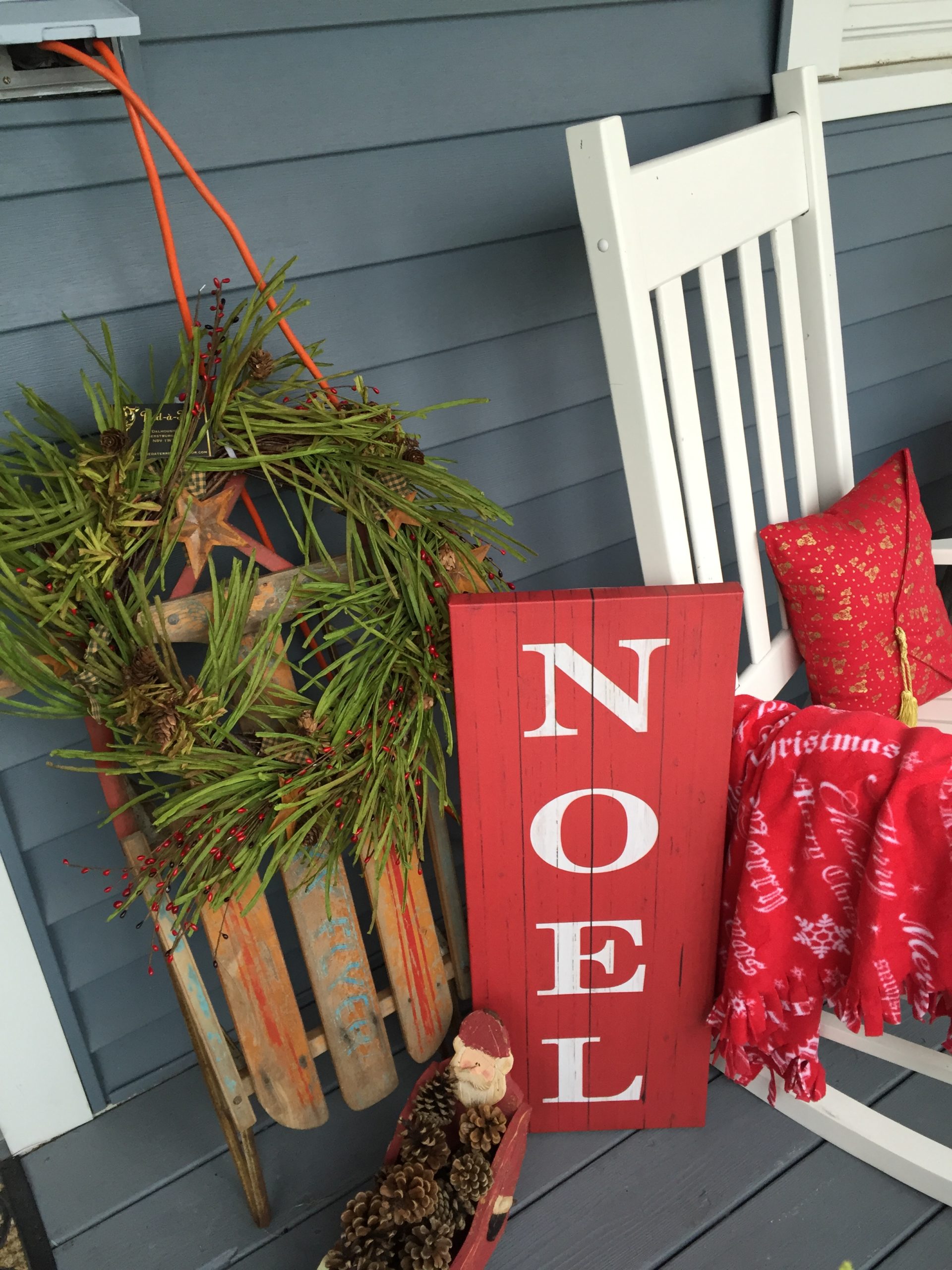 Holiday sleigh and decor on a porch