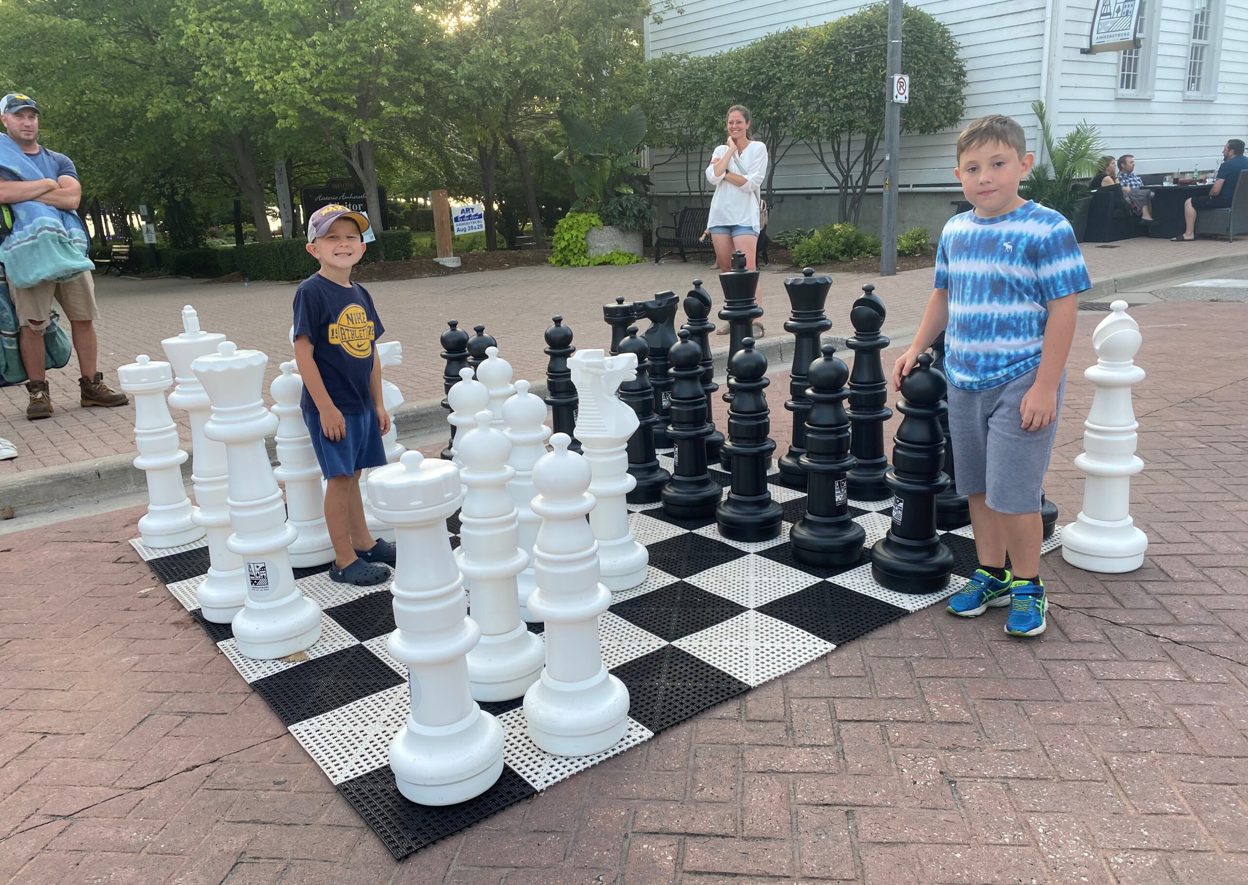 Two boys playing life-sized chess