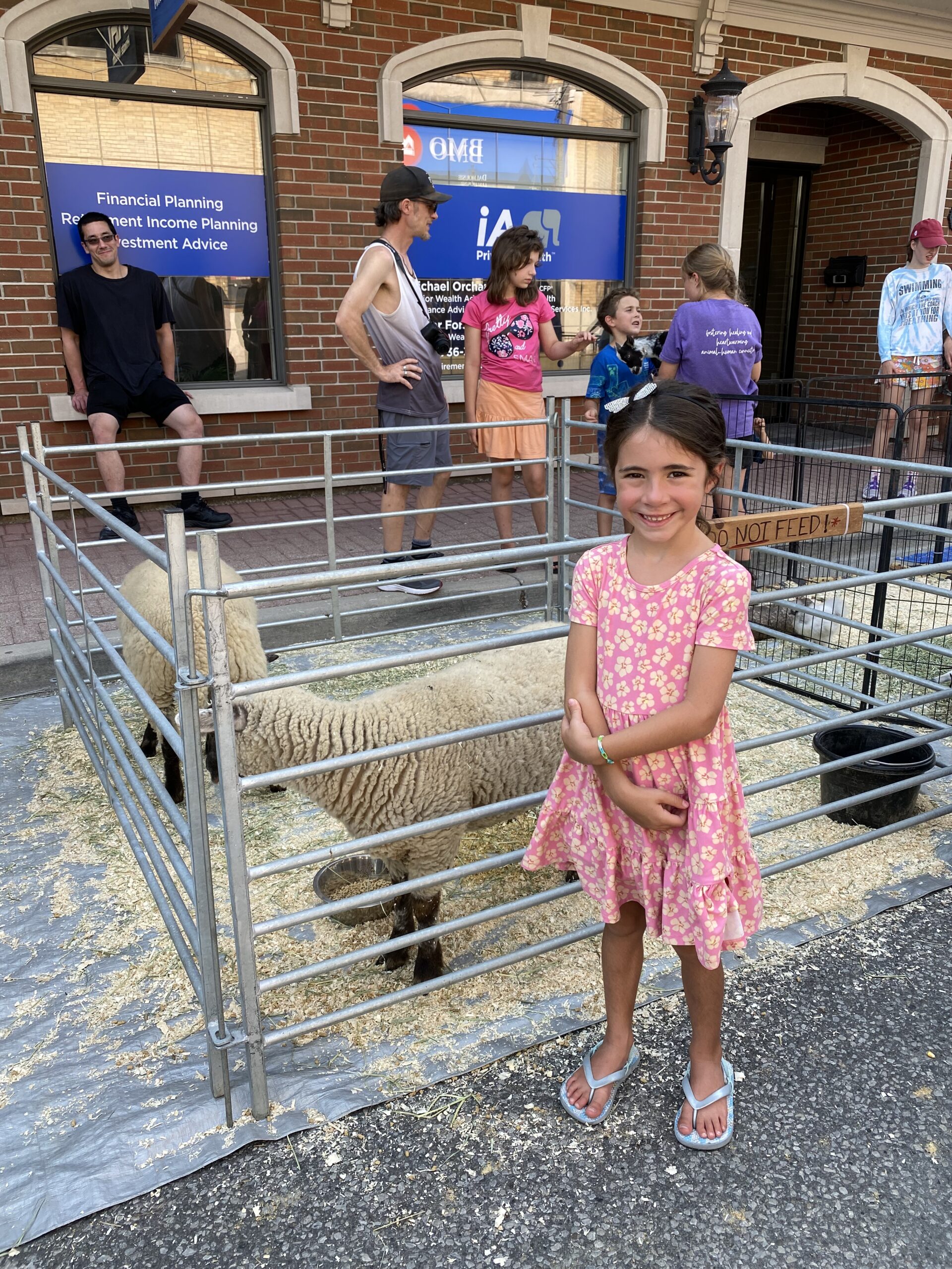 girl posing with sheep at Farm Fest on Dalhousie Street