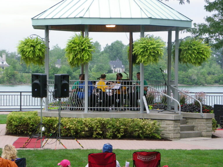 <p>Group playing music under gazeboo</p>