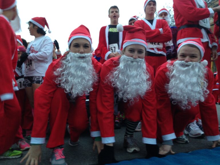 <p>Three girls dressed as Santa Claus prepare to run at the Super Santa Walk/Run/Wheel event.</p>