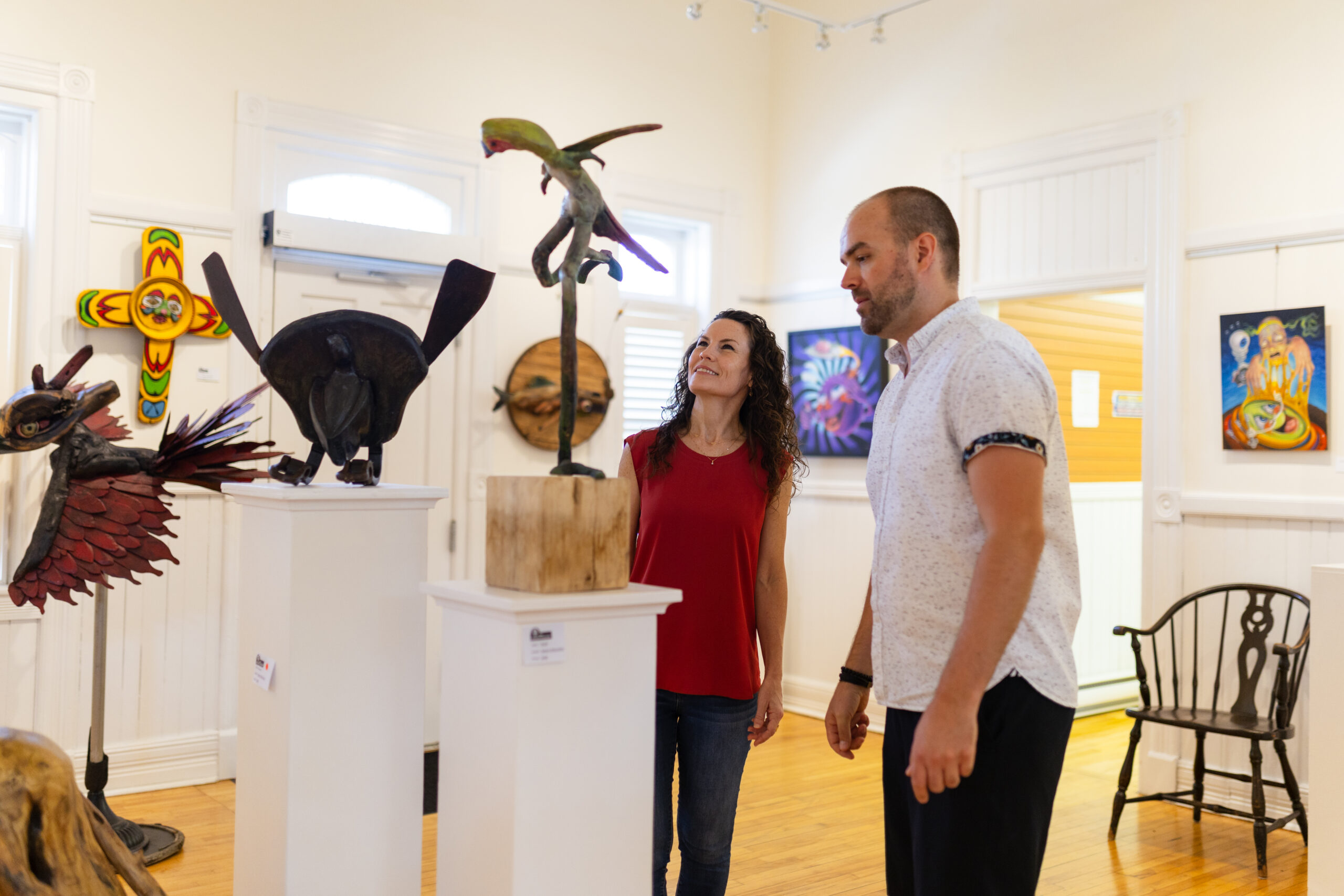 Two people viewing an art exhibit at the Gibson Gallery