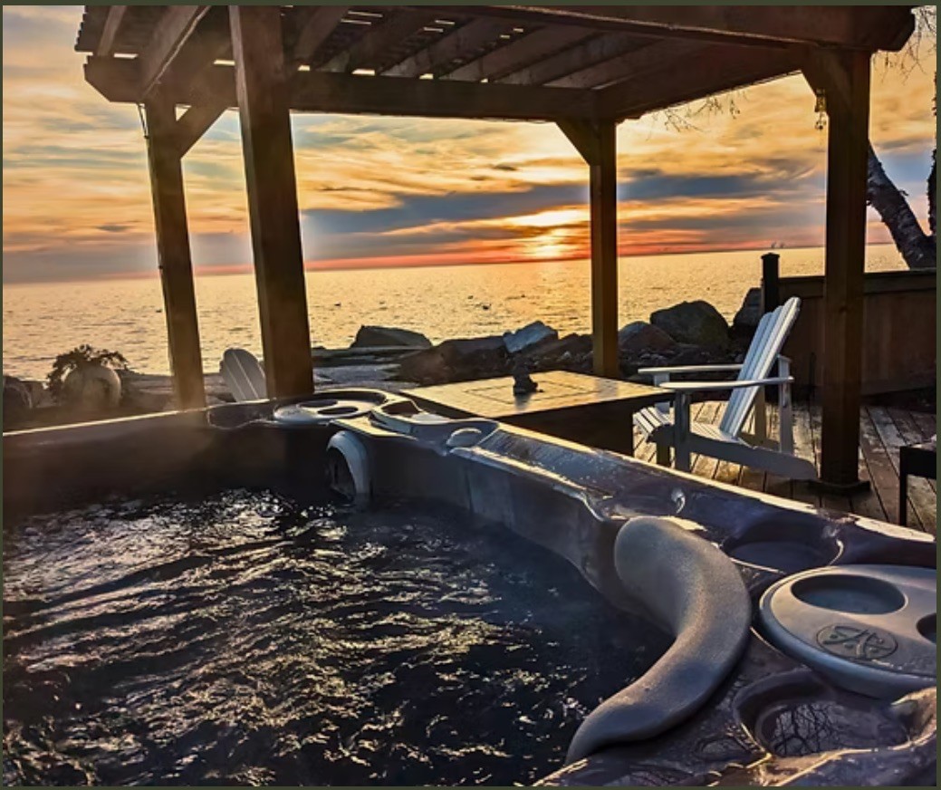 Image of a hot tub overlooking Lake Erie during a sunset